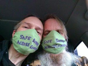 brian and kenn wearing green masks reading safe supply across canada